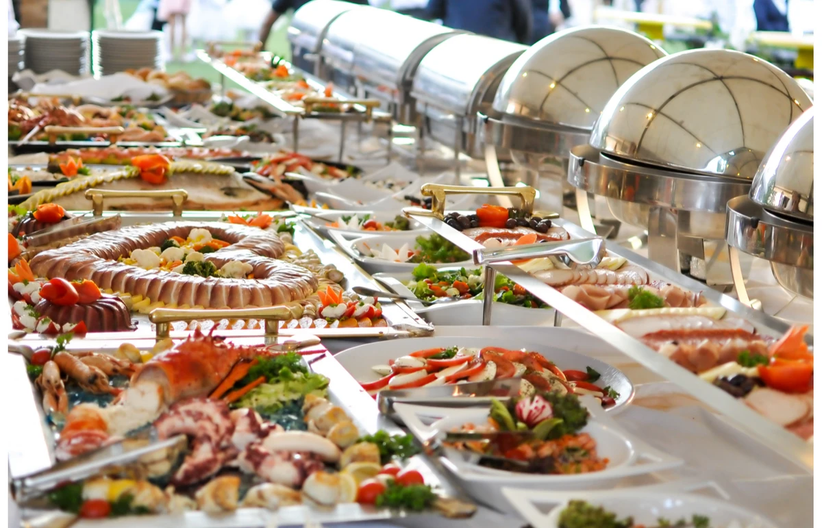 Buffet catering setup with fresh dishes and serving trays