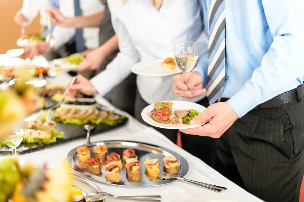 Family meal service with shared dishes prepared by a caterer